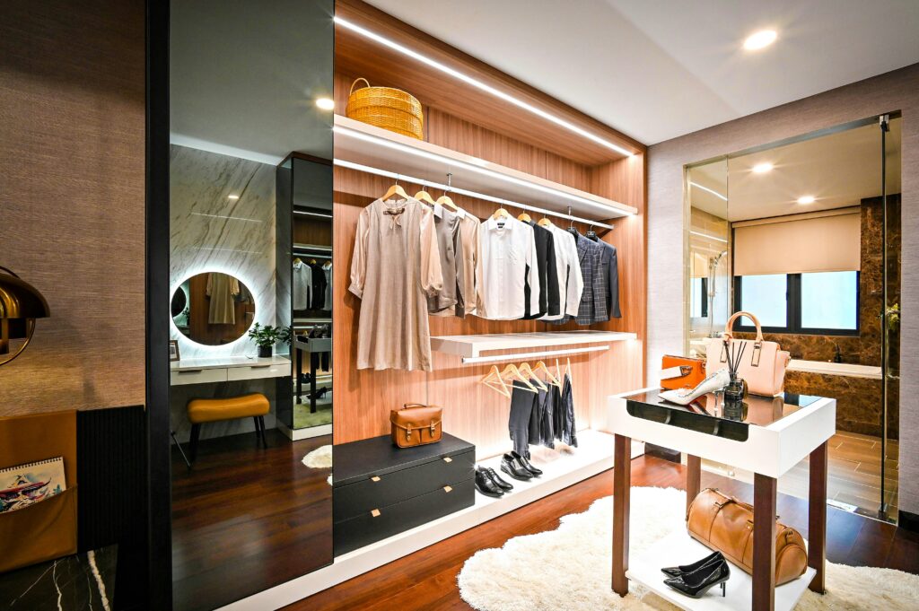 Elegant dressing room with organized clothing, shoes, and accessories.